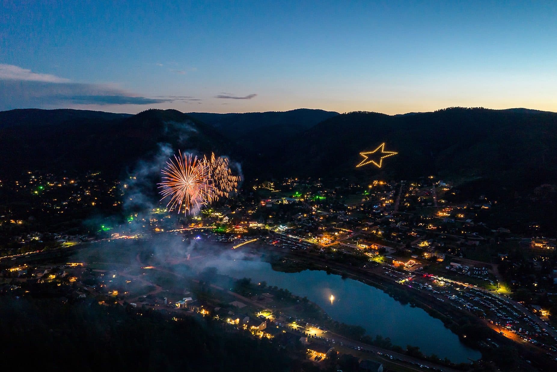 Aerial view of Palmer Lake Fourth of July fireworks with the Star on the hill