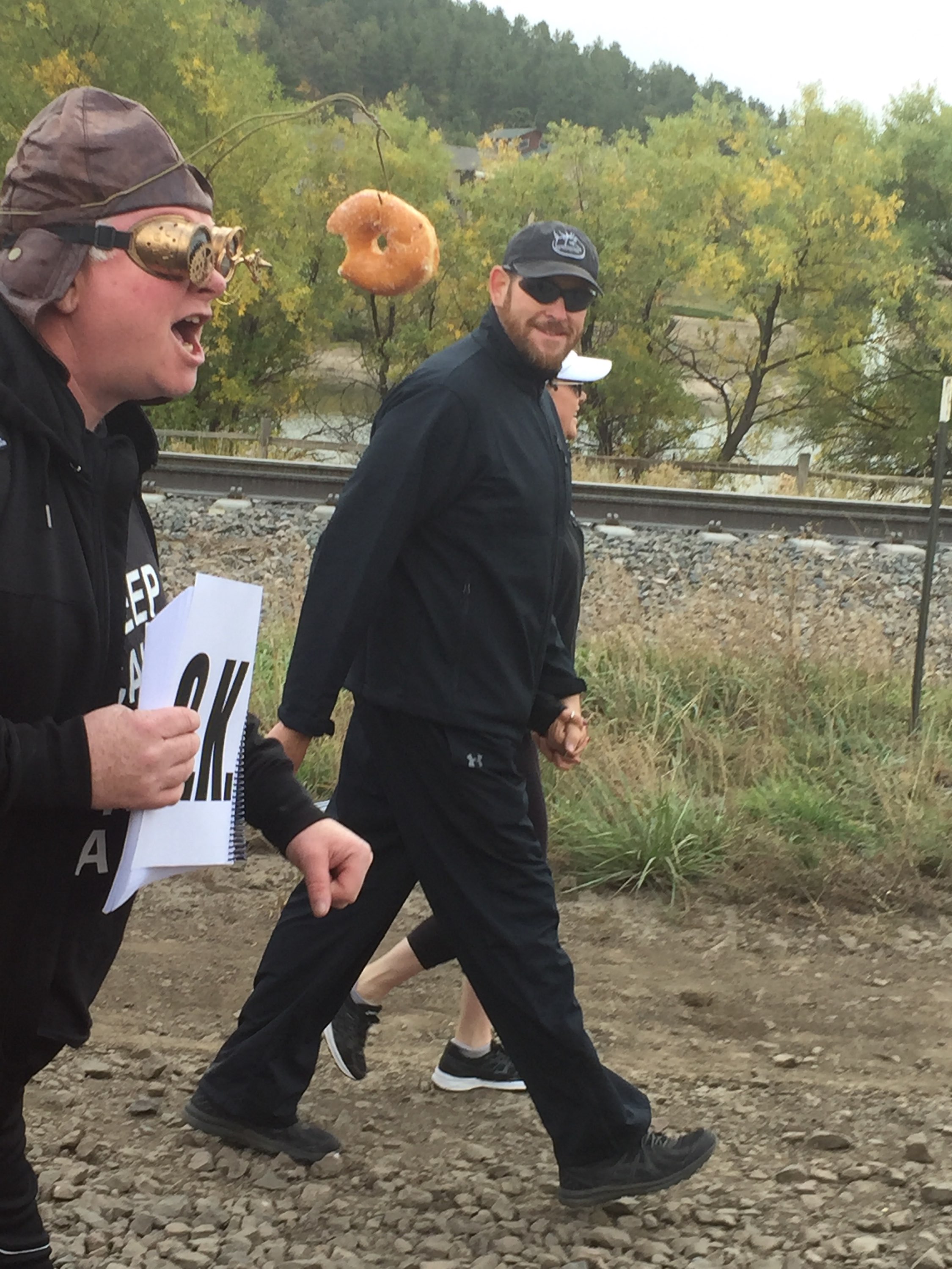 A runner dangling a donut on a fishing pole at the .5K